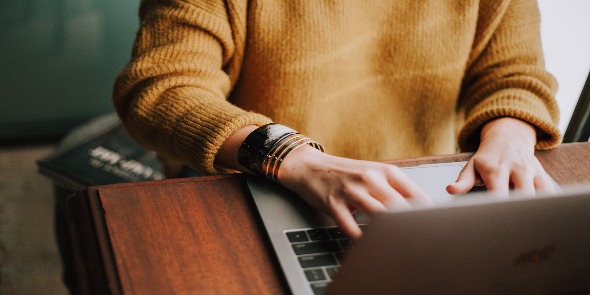 Image of person typing on laptop. Photo by Christin Hume on Unsplash.