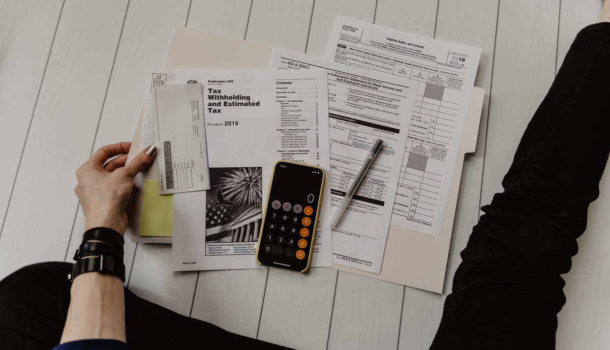 Image of tax documents and calculator. Photo by Kelly Sikkema on Unsplash.